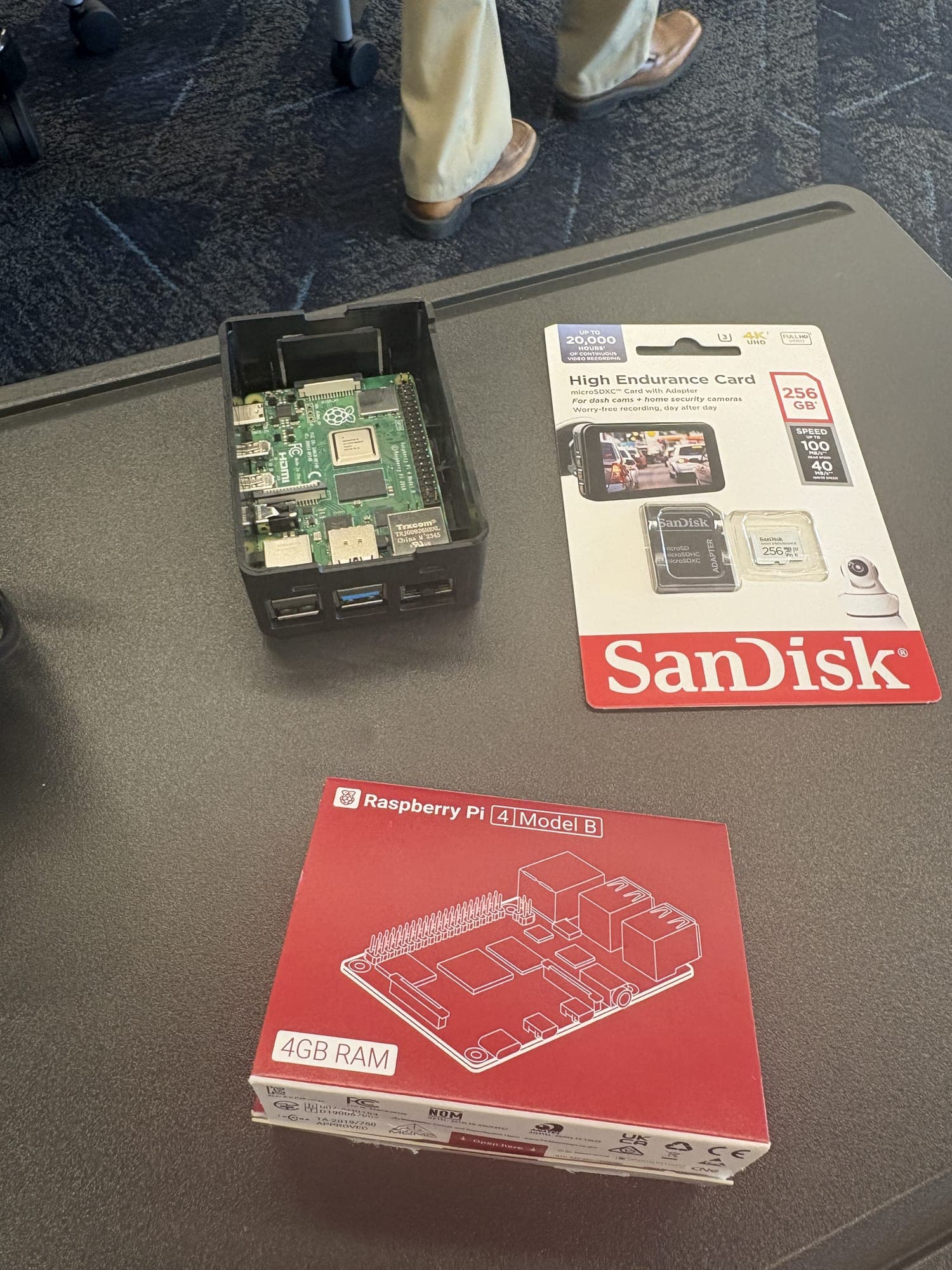 The same Raspberry Pi, card and retail box laid out on a table part-way through assembly.